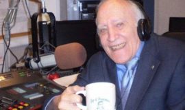 Jim Roselle in the WJTN studio with his cup of happiness.