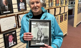 Judy Young holds a photo of her son Jim, a 2013 CSHOF inductee. 2023.