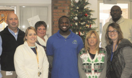 Members of the Employee of the Month Team at G.A. Family Services congratulate Maceo Wofford.