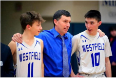Westfield head coach Nolan Swanson shares a moment with his sons Carson (11) and Darien (10). March 2 2022.