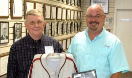 Russ Ecklund, left, accepts from Ted Wyberanec a jersey his father wore.