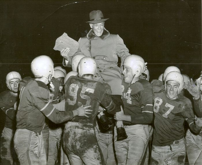 Dr. Harold Blaisdell is carried from the field by the Jamestown High School football team in this 1954 photo.