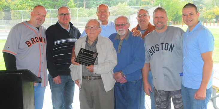 Joining in the dedication of the Little League field in Walt Brown’s name are, from the left, Bradley Brown, grandson; Kris Brown, grandson; Arden Johnson, Town of Ellery supervisor; Tom Brown, son; Barry Brown, son; John Cresanti, Town of Ellery council member; Doug Brown, grandson; and Andy Brown, grandson.