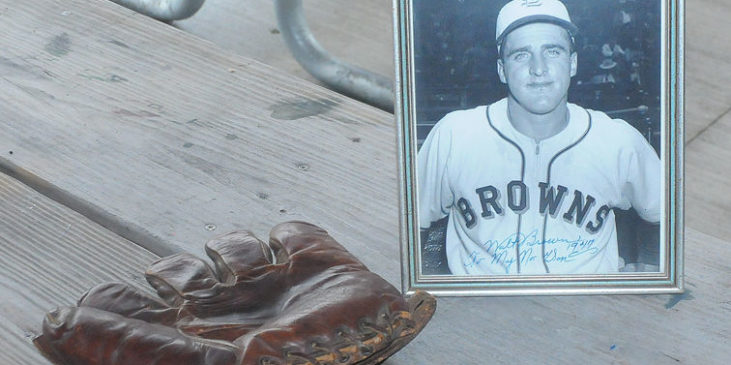 photo of Walt Brown on picnic table beside his baseball glove