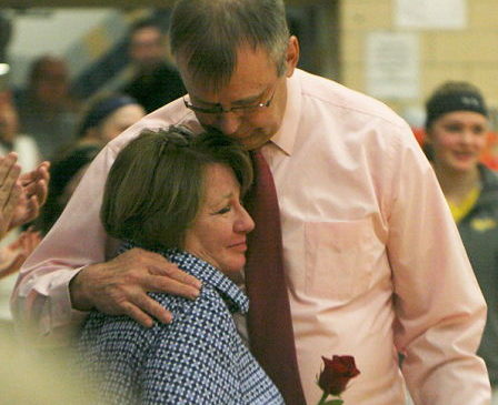 Sherman coach Mel Swanson hugs his wife, Mary.