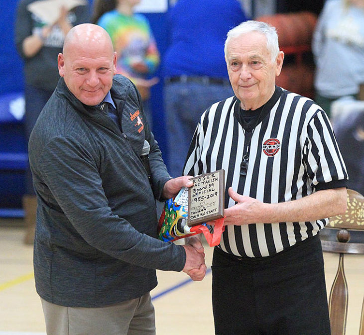 Loren Smith, a modified boys and girls basketball coach at Panama, presents MacTavish with a plaque.