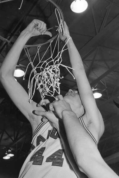 Mike McElrath cuts down the nets.