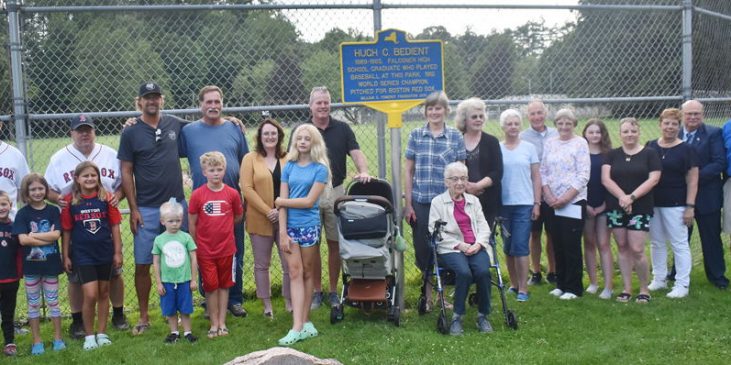 Bedient family members, village officials and friends pose for a photograph with the marker.