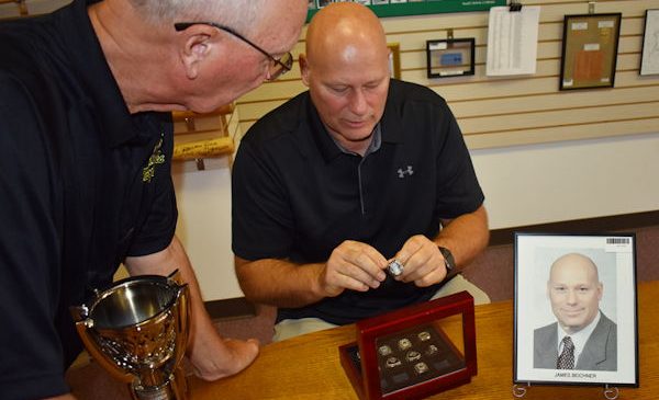 Jim Beichner with Randy Anderson looking at his rings.