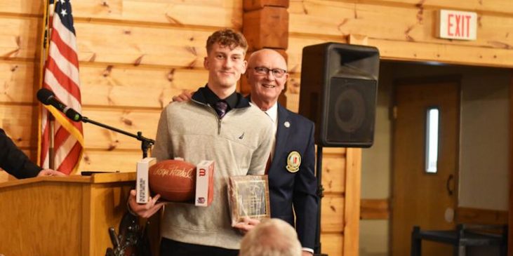Fredonia’s Ethan Fry is honored by Randy Anderson.