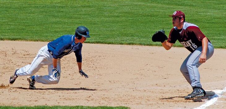 Jonathan Wilson dives back to first base.