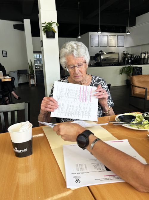 Judy Young looks over the National Senior Games swim schedule.