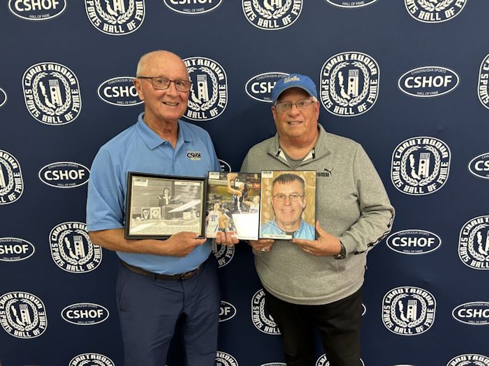 Randy Anderson and Bob Goold hold CSHOF inductee photos.