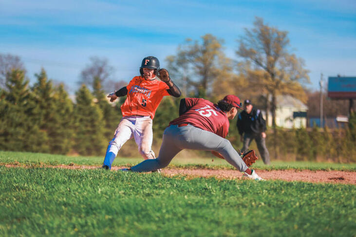 Fredonia’s Matt Cowan gets back to first base