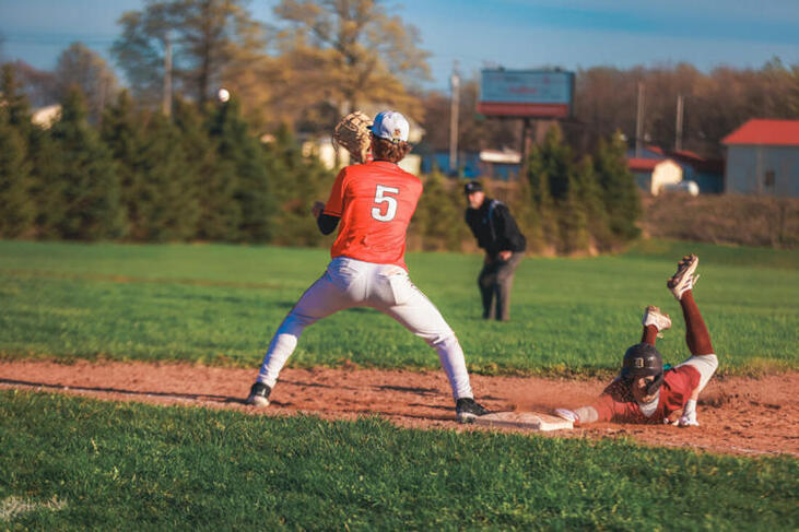 Fredonia's Matt Cowan receives a throw as Dunkirk's Gabe Valentine dives back to the base.