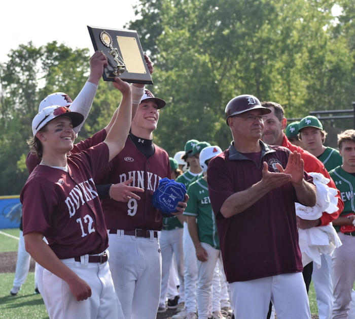 Dunkirk seniors Greg Orcutt (9), Paul Trippy III (12) and Dylan Bankoski (hidden) hold up the Section VI championship plaque behind head coach Frank Jagoda.