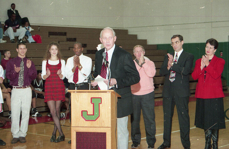 Jim McElrath addresses the crowd after the Jamestown High School gym was named in his honor.