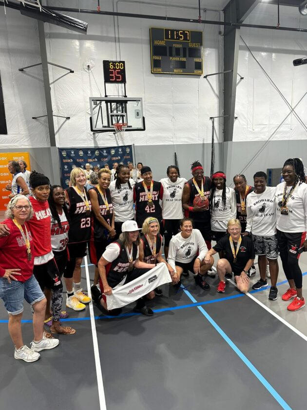 Kneeling, second from left, Cheryl Burns joins her Broward County (Fla.) Heat teammates.