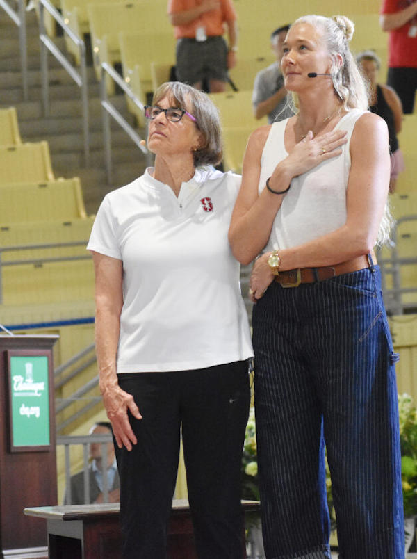 Tara VanDerveer, left, and Kerri Walsh Jennings stand for the national anthem.
