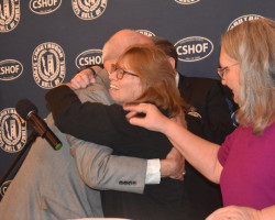 2024 inductee Karen Tellinghuisen hugs CSHOF president Randy Anderson. At right is American Sign Language interpreter Janelle Krueger. 2024 inductee Karen Tellinghuisen hugs CSHOF president Randy Anderson. At right is American Sign Language interpreter Janelle Krueger.