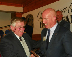 Greg Peterson and Shane Conlan. Greg-Peterson-accepting-for-Peter-Mueller