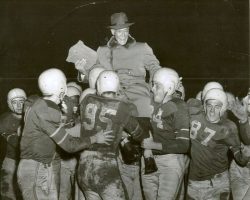 Dr. Harold Blaisdell is carried from the football field in this 1954 photo. Harold Blaisdell 1954