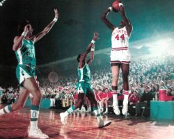 Scoring sensation David Thompson hangs in the air to get off a shot over straining Carolina defenders Donn Johnston (left) and Ray Harrison.
Courtesy Sports Illustrated, December 25, 1972 Scoring sensation David Thompson hangs in the air to get off a shot over straining Carolina defenders Donn Johnston (left) and Ray Harrison.