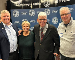 Tom Anderson (Class of 2025) and Sheilah Gulas (Class of 2018) are flanked by Tom's brothers. Tom Anderson (Class of 2025) and Sheilah Gulas (Class of 2018) are flanked by Tom's brothers.