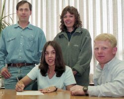 Brianne Prince Hazelton signing letter of intent with St. Bonaventure University. Behind her are her parents, Tim and Kim Prince. Seated beside her is her coach Jon Blanchard. Brianne Prince Hazelton signing letter of intent with St. Bonaventure University.