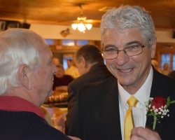 Chautauqua Sports Hall of Fame Class of 2011 inductee Bob Wisniewski, left, speaks to 2020 inductee Mark Orlando on Monday night during the induction dinner at the Lakewood Rod & Gun Club. <em>Post-Journal</em> (Jamestown), February 18, 2020. P-J photo by Scott Kindberg. CSHOF-Mark-Orlando-with-Bob-Wisniewski-2-17-2020