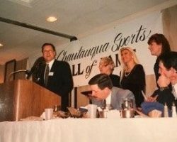 Chris Olsen accepts induction on behalf of his late father,
Ted, at the 1999 banquet along with Ted's wife Jan Present, and
Ted's daughters, Sharyn and Cindy. Chris Olsen accepts induction on behalf of his late father, Ted, at the 1999 banquet.