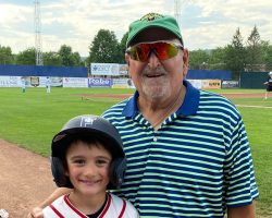 Gregg Bender (right), son of CSHOF inductee Bob Bender, with his grandson, Karter.
The Benders were the honorary coach and bat boy for the Jamestown Tarp Skunks July 20, 2022 game at Diethrick Park.
Karter is wearing the Jamestown Steel Partition Bombers jersey that Gregg wore in 1957 when he was a bat boy for his father's team at this very ball park, then called Municipal Stadium. Karter sat in the same dugout as his great-grandfather and grandfather did 65 years ago. Gregg Bender (right), son of CSHOF inductee Bob Bender, with his grandson, Karter.