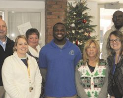 Members of the Employee of the Month Team at G.A. Family Services congratulate Maceo Wofford on being selected as the G.A. 2016 Employee of the Year. Left to right: Timothy McMullen, Interim Director of Education, Kimberly Breneman, Maceo Wofford, Liz Lobb, Donna Ciancio, Betsy Woleen and Karl Wiggins, Vice President of G.A. Family Services. <em>Observer</em> (Dunkirk), January 14, 2017. Members of the Employee of the Month Team at G.A. Family Services congratulate Maceo Wofford.