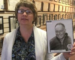 Nancy Nelson, daughter of Ramsay Riddell, with photo of her dad at the CSHOF.