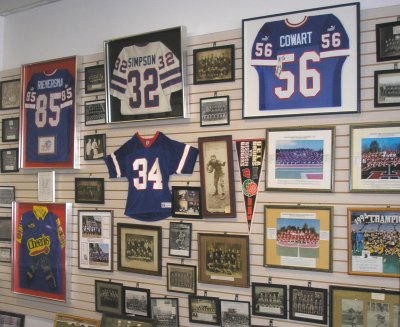 Donated photos, jerseys and other memorabilia are displayed on a wall in the exhibit hall.