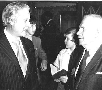 Frank Hyde, right, talks with broadcaster Curt Gowdy.
