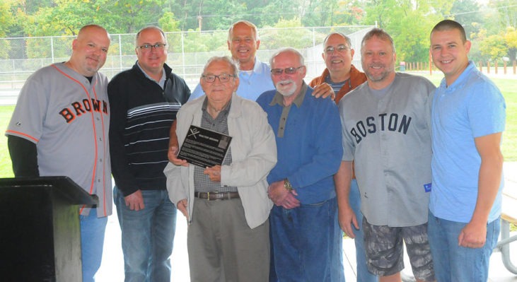 Joining in the dedication of the Little League field in Walt Brown’s name are, from the left, Bradley Brown, grandson; Kris Brown, grandson; Arden Johnson, Town of Ellery supervisor; Tom Brown, son; Barry Brown, son; John Cresanti, Town of Ellery council member; Doug Brown, grandson; and Andy Brown, grandson.