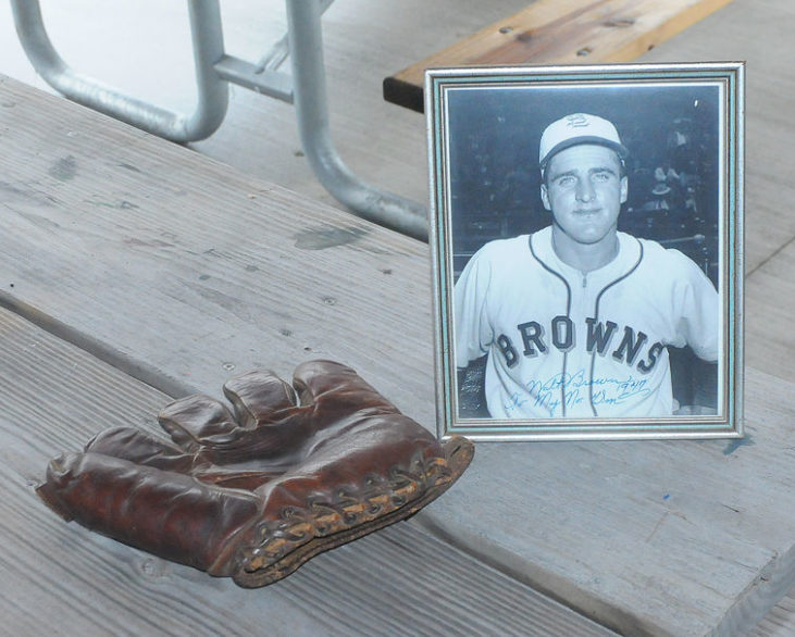 photo of Walt Brown on picnic table beside his baseball glove