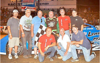 With his Super Late Model performance Saturday night, Dick Barton tied Bob Schnars for most career wins at Stateline Speedway with 79. After the victory, Barton, standing third from right, is joined by his race team. Kneeling, from the left, are Charlie Lacki, Greg Farrar and Keith Carlson. Standing, from the left, are Doug Wood, John Lamb, Del Seekings, Barton, Randy Anderson and Ryan Seekings.