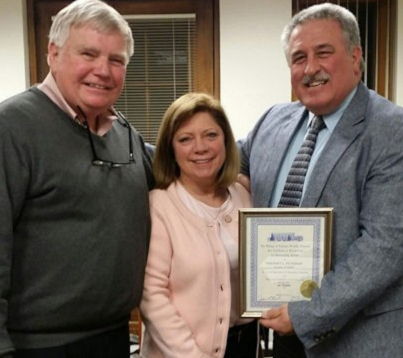Greg and Amy Peterson with Falconer Mayor James Rensel.