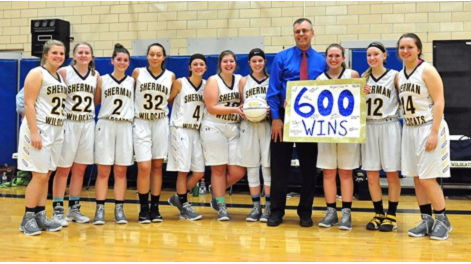 Sherman Central School girls basketball coach Mel Swanson poses for a photo with his team after the Lady Wildcats held off Maple Grove.