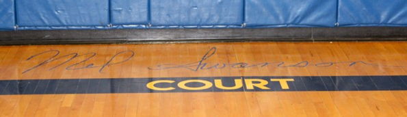 "Mel Swanson Court" is painted on floor of gymnasium.