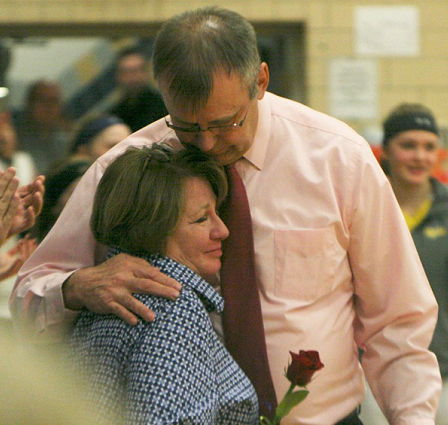 Sherman coach Mel Swanson hugs his wife, Mary.
