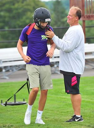 Curt Fischer coaching young player.