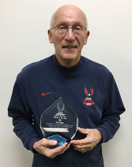 Tom Priester holds the trophy he was presented upon being selected the USA Track & Field Niagara Association Official of the Year.