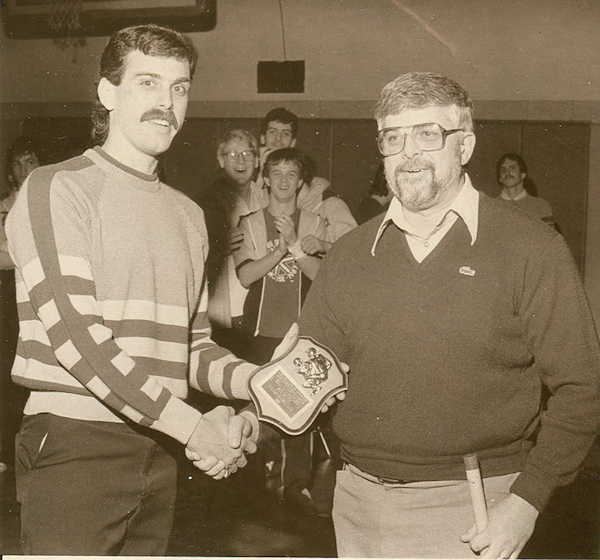 Sam Ognibene presents a commemorative plaque to Falconer wrestling coach Bill Davenport.