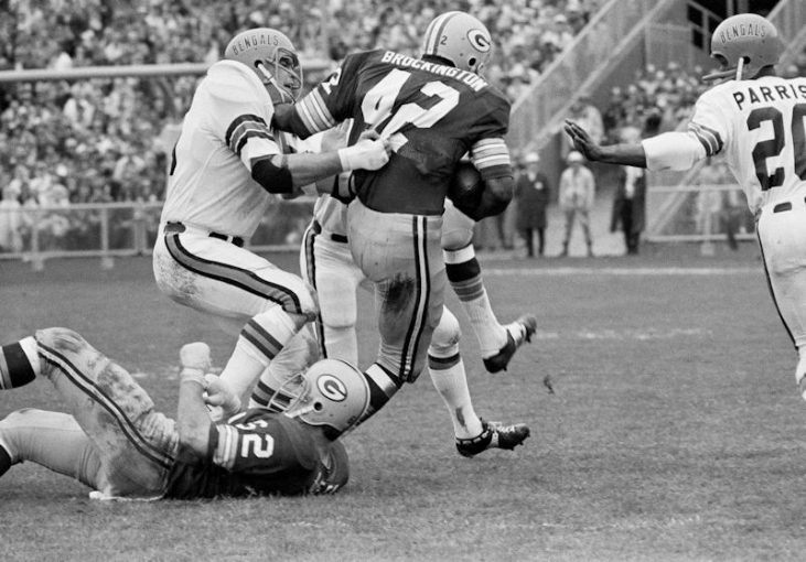 Bill Bergey hauls down John Brockington.