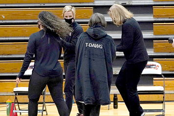 Stanford coach Tara VanDerveer, center, wears an overcoat with “T-DAWG” on the back.