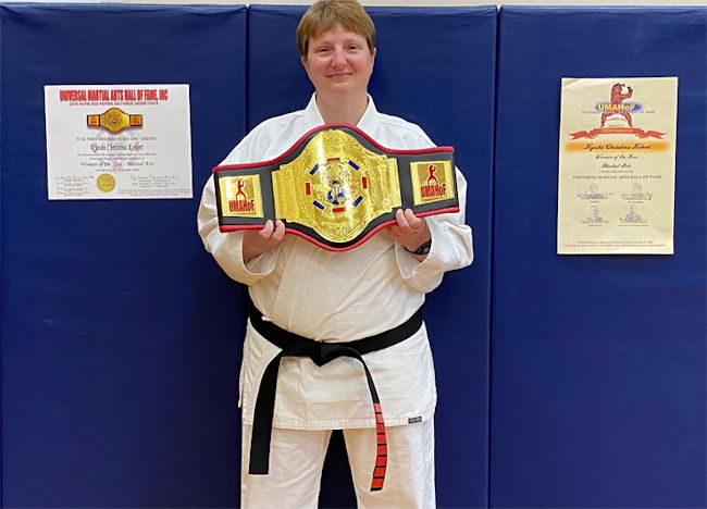 Christina Kebort displays her 2020 Woman of the Year award/