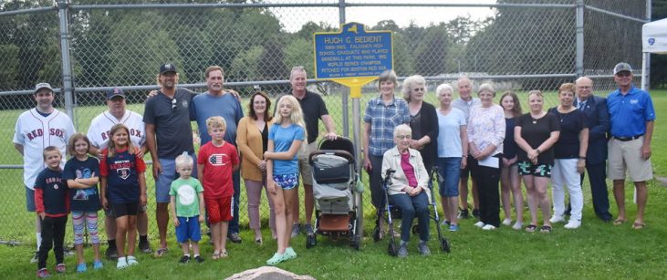 Bedient family members, village officials and friends pose for a photograph with the marker.